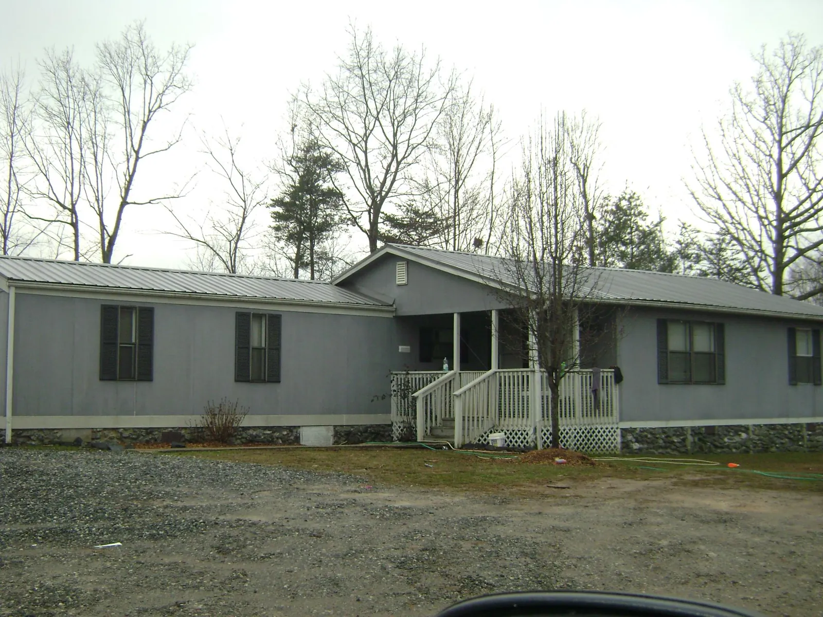 Metal roof over a manufactured home with a covered front porch in Kerhonkson
